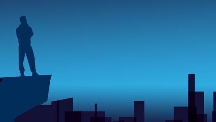 Symbolbild Silhouette einer Großstadt, ein Mann steht auf einem Hochhaus.